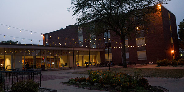 Outside of Armstrong/Douglas with lights on at night