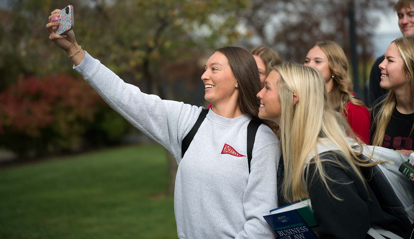 Coe students smiling taking a selfie