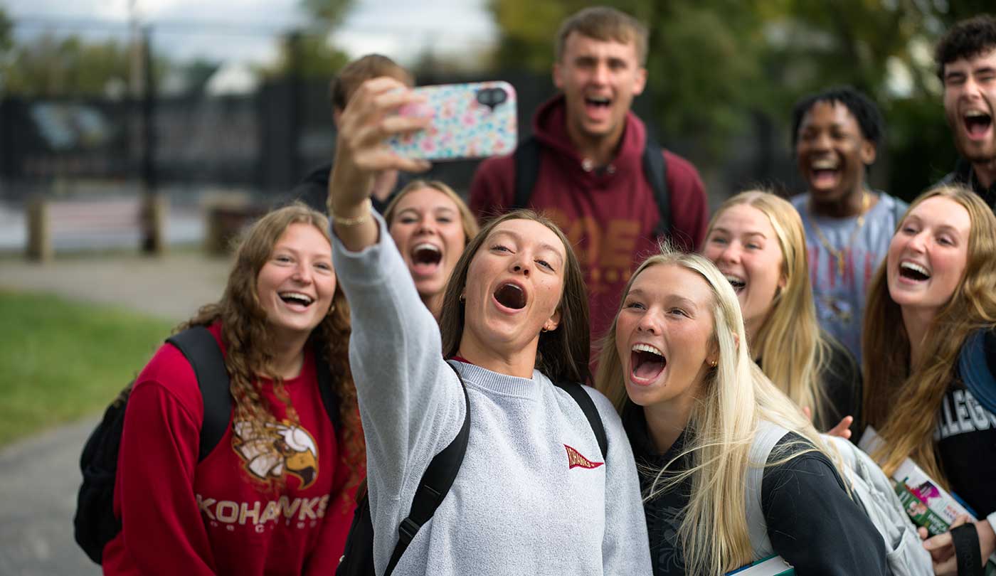 Coe students cheering and taking a selfie