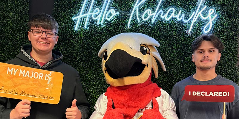 Two students with Charlie holding I Declared signs