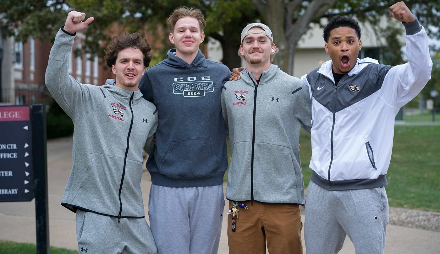 Four male Coe students cheering