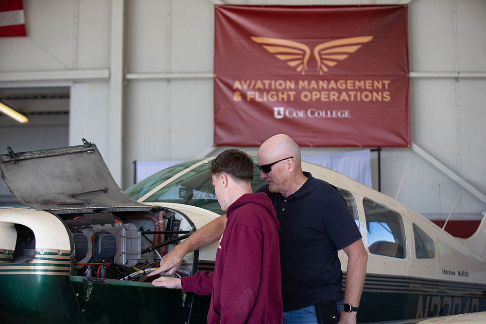 Tim Busch and student perform pre-flight check